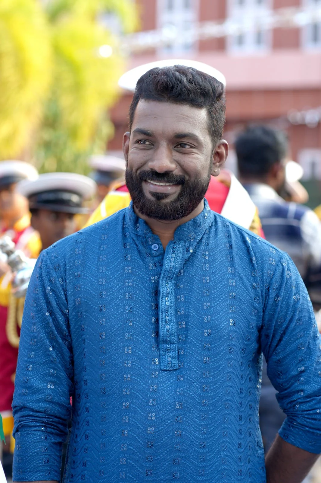 Arun Guinness smiling in a blue kurta between performances